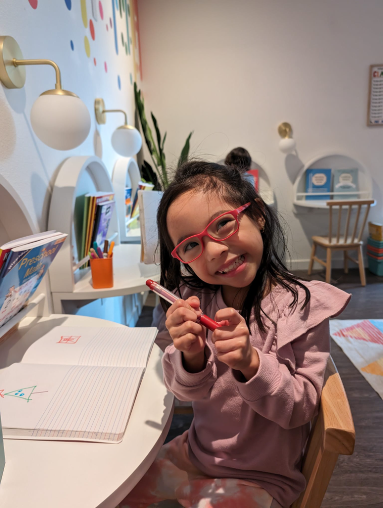 A happy student drawing at the Academy